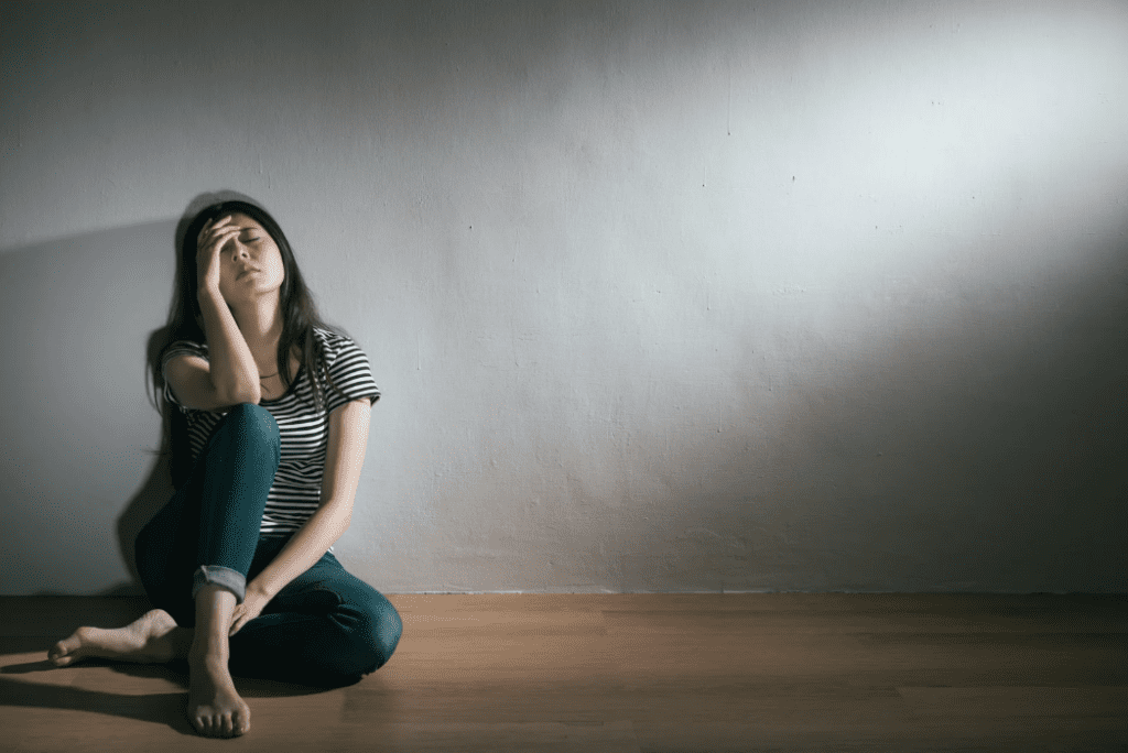 A woman sitting in an empty room.